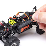 Axial 1/30 scale SCX30 Chevrolet K10 4x4 RTR brushed rock crawler on rugged terrain with detailed body and off-road tires.