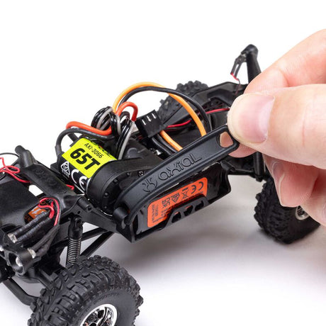 Axial 1/30 scale SCX30 Chevrolet K10 4x4 RTR brushed rock crawler on rugged terrain with detailed body and off-road tires.