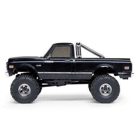 Axial 1/30 scale SCX30 Chevrolet K10 4x4 brushed rock crawler vehicle on rough terrain