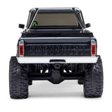 Axial 1/30 scale SCX30 Chevrolet K10 4x4 RTR brushed rock crawler on rugged terrain with detailed body and off-road wheels.