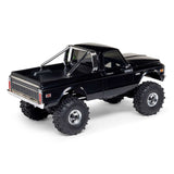 Axial 1/30 scale SCX30 Chevrolet K10 4x4 brushed rock crawler model on rugged terrain.