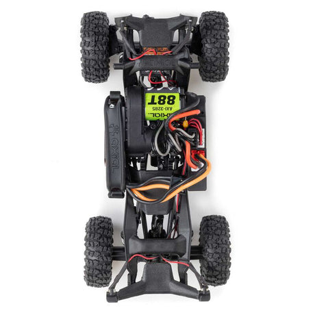 Axial 1/30 scale SCX30 Jeep Wrangler JLU 4x4 rock crawler with brushed motor, detailed off-road RC vehicle on rugged terrain
