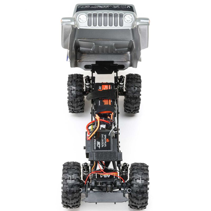 Axial SCX24 Summit Racing Jeep Gladiator 4x4 rock crawler RTR shown on rugged terrain with detailed exterior and off-road features.