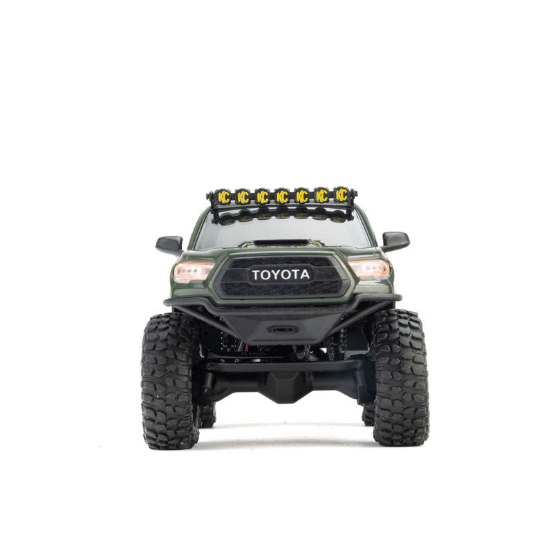 Axial SCX30 Toyota Tacoma TRD Pro 1/30 scale remote control rock crawler on rugged terrain