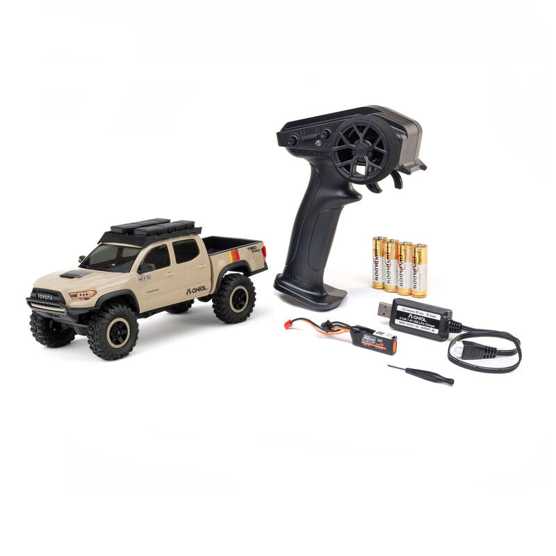 Axial SCX30 Toyota Tacoma TRD Pro 1/30 scale RC rock crawler on rugged terrain with detailed truck body and off-road tires.