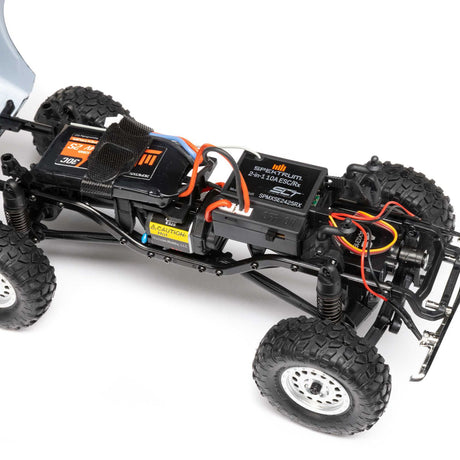 Axial 1/24 scale SCX24 Chevrolet C10 4WD truck RTR model with detailed blue and white body and rugged off-road tires.