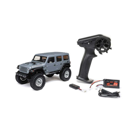 Axial 1/24 SCX24 2019 Jeep Wrangler JLU CRC 4X4 brushed rock crawler on rugged terrain with detailed exterior and off-road features.