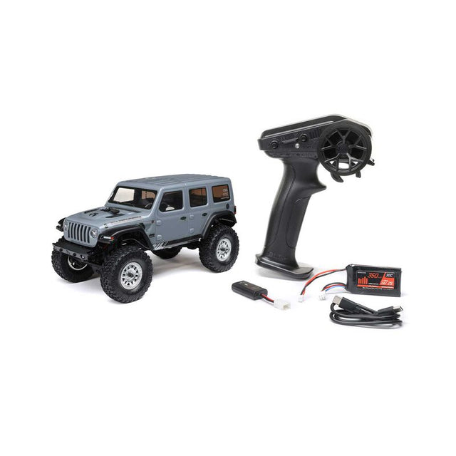Axial 1/24 SCX24 2019 Jeep Wrangler JLU CRC 4X4 brushed rock crawler on rugged terrain with detailed exterior and off-road features.