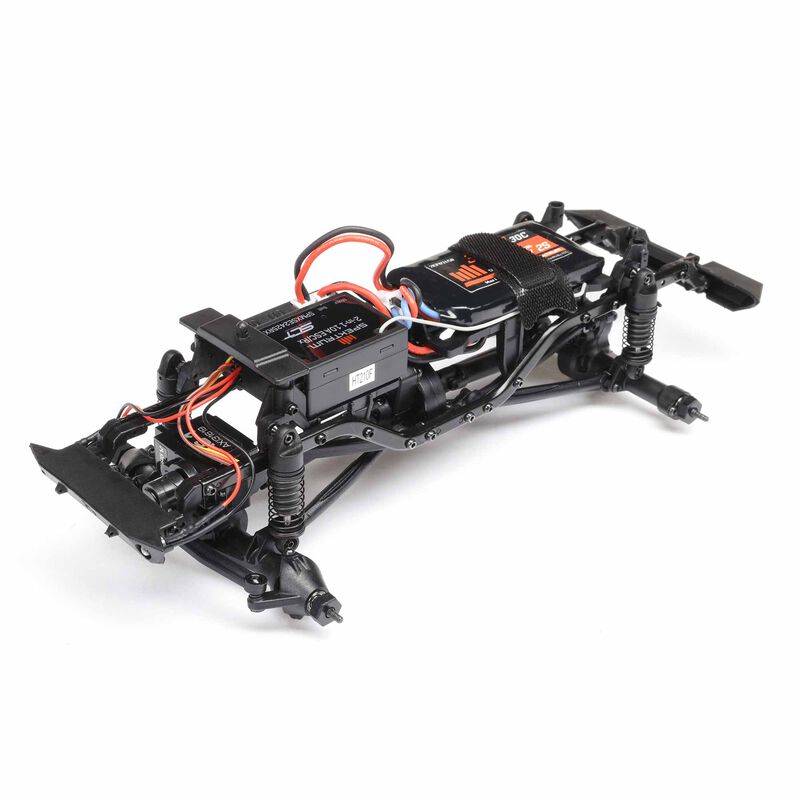 Axial 1/24 SCX24 Jeep Wrangler JLU CRC 4x4 brushed rock crawler model on rugged terrain with detailed exterior features.