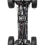 Axial 1/24 SCX24 Jeep JT Gladiator 4x4 RTR brushed rock crawler on rough terrain with detailed exterior and rugged tires.