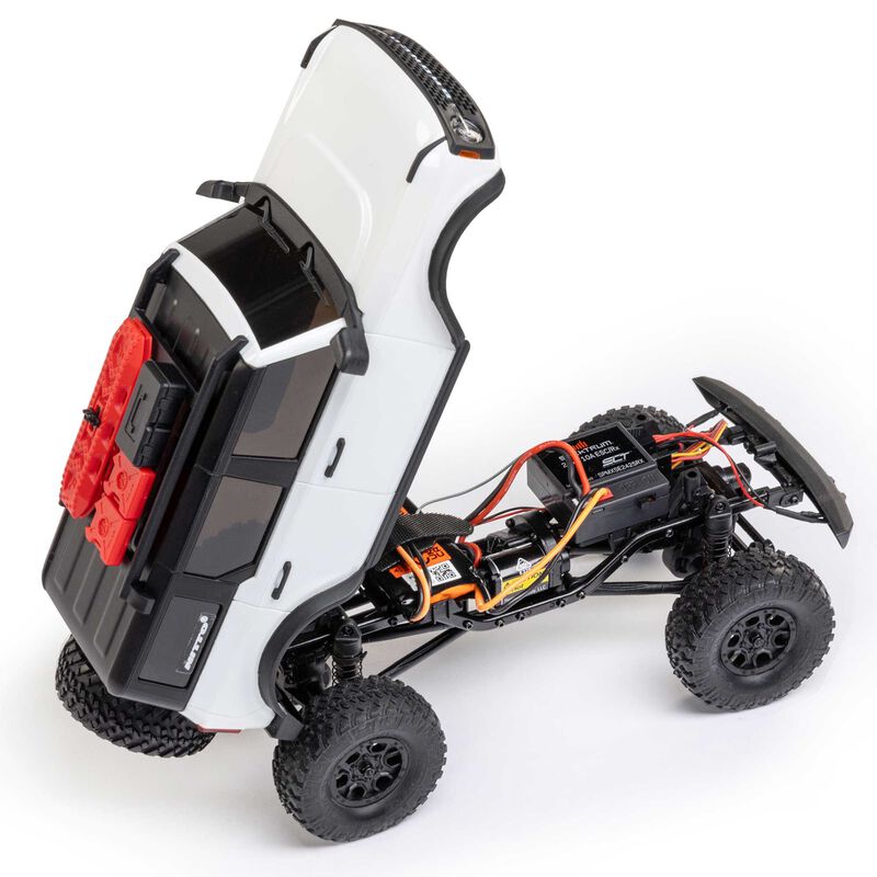 Axial 1/24 SCX24 Ford Bronco 4x4 RTR brushed rock crawler on rugged terrain with detailed exterior and off-road tires.