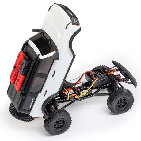 Axial 1/24 SCX24 Ford Bronco 4x4 RTR brushed rock crawler on rugged terrain with detailed exterior and off-road tires.