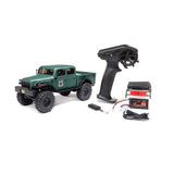 Axial 1/24 SCX24 Dodge Power Wagon 4X4 RTR brushed rock crawler on rough terrain with detailed exterior and rugged tires.