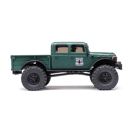 Axial 1/24 SCX24 Dodge Power Wagon 4x4 RTR brushed rock crawler on rugged terrain with detailed exterior and off-road tires.