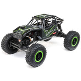 Black and green Axial 1/18 scale UTB18 Capra 4WD RTR trail buggy on rugged terrain.