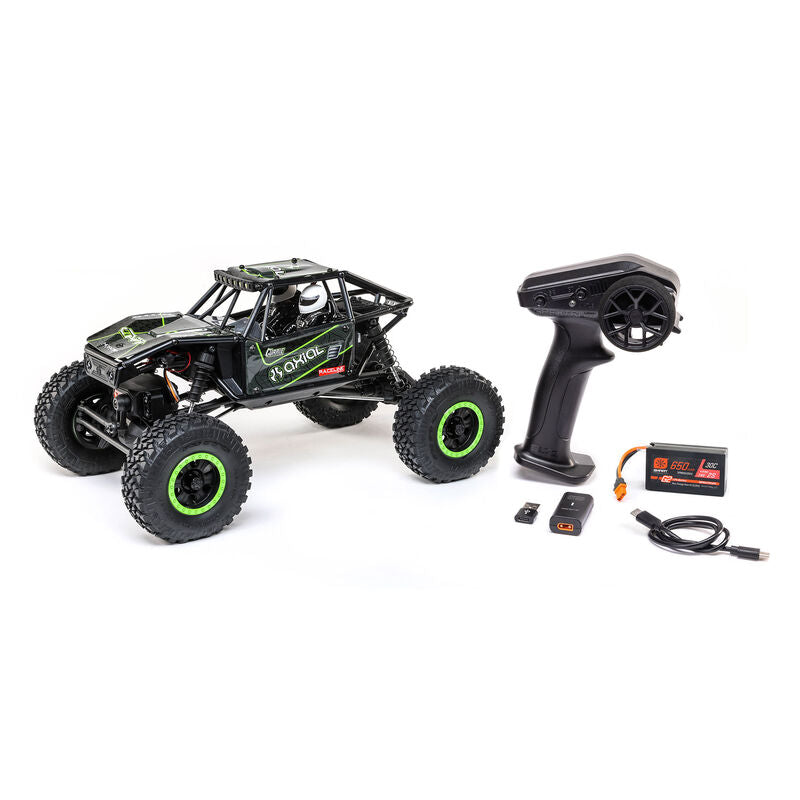 Black and green Axial 1/18 UTB18 Capra 4WD RTR trail buggy on rugged terrain.