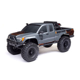 Axial 1/10 SCX10 III Base Camp 4x4 RTR brushed rock crawler in gray, showing off its rugged off-road design and detailed exterior.