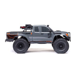 Axial 1/10 SCX10 III Base Camp 4x4 RTR brushed rock crawler in gray, showing the rugged off-road vehicle with detailed exterior.