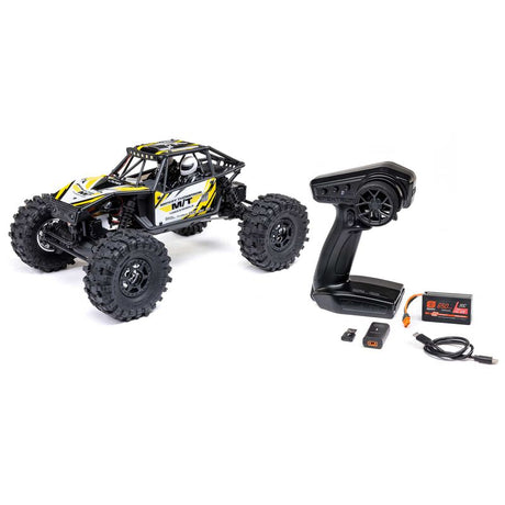Axial 1/18 Capra 4WS brushed rock crawler with detailed chassis and four-wheel steering in off-road terrain.