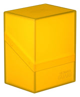 Yellow Ultimate Guard Boulder 80+ deck case for card storage, featuring a sturdy, compact design for trading card protection.