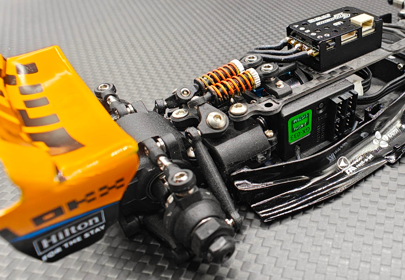Rear view of GL Racing 1/28 scale Formula One chassis showcasing detailed racing car frame and suspension components.