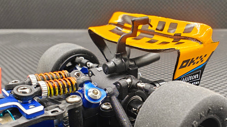 Rear view of a GL Racing 1/28 scale Formula One chassis showing detailed aerodynamic parts and suspension components.