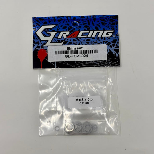 GL Racing Formula One shim set with multiple metal shims arranged for engine tuning and performance adjustment.