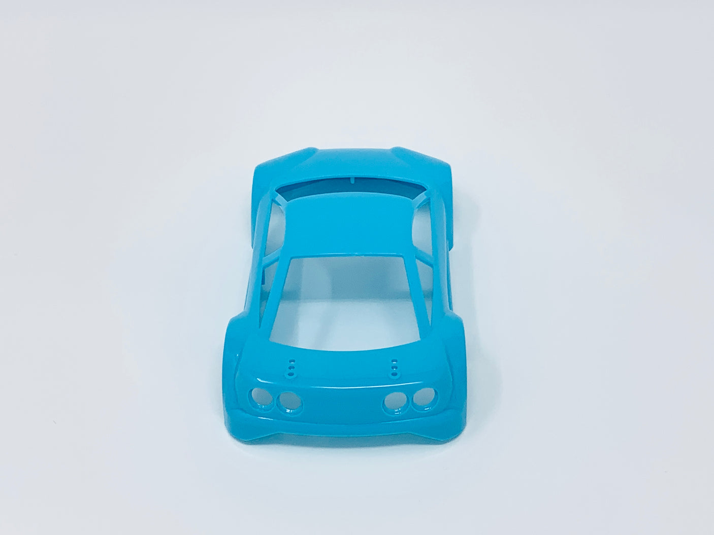 Jomurema GT01 car body set in neon blue, featuring sleek aerodynamic design and detailed finish, for custom vehicle modification.