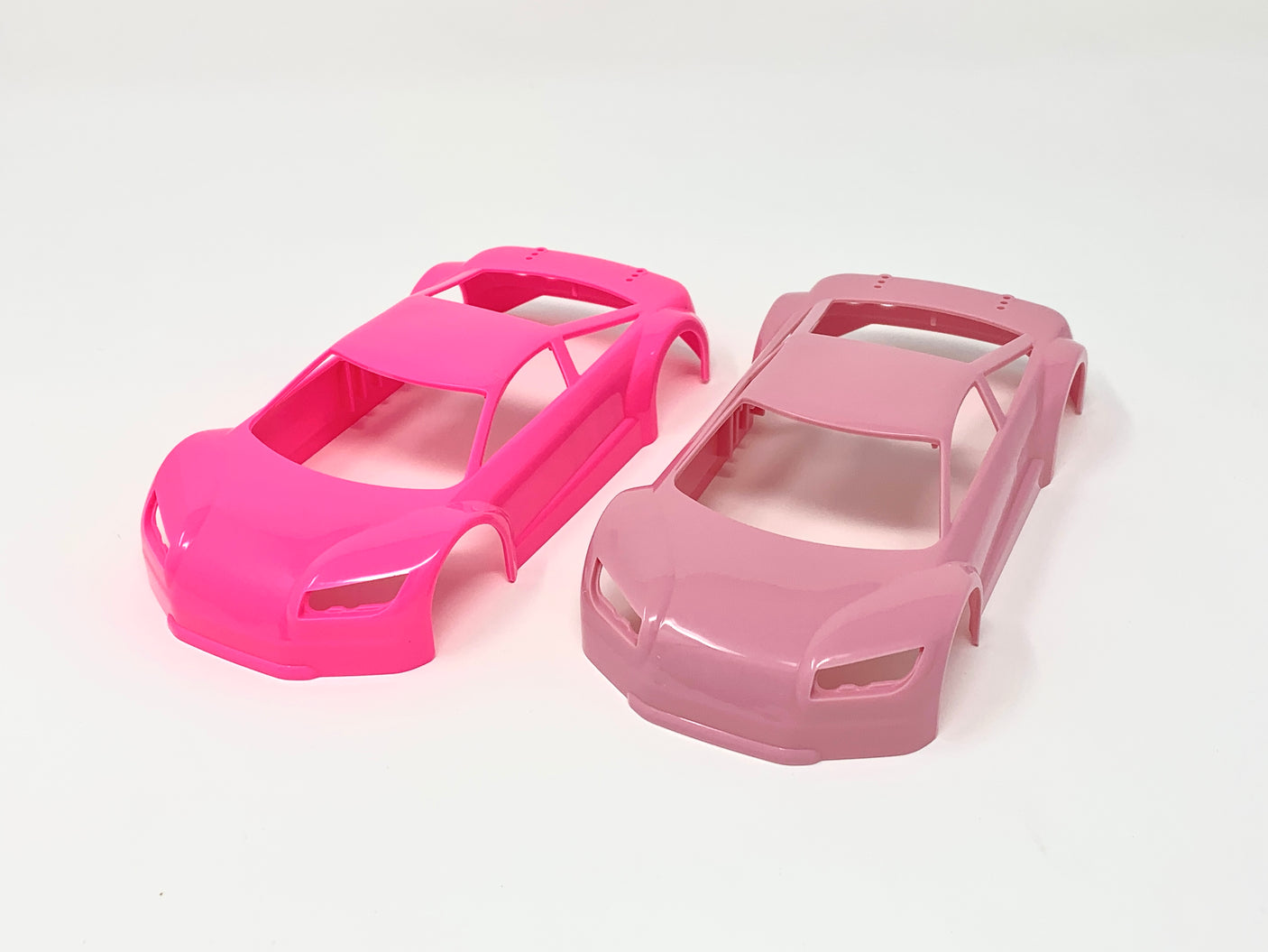 Jomurema GT01 car body set in vibrant neon pink with a sleek, aerodynamic design, perfect for customizing sports cars.