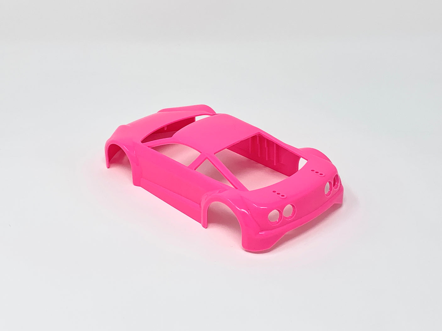Jomurema GT01 car body set in vibrant neon pink, featuring detailed design and aerodynamic shape for racing or show cars.