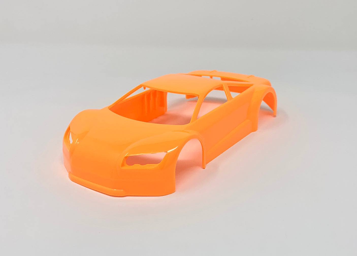 Jomurema GT01 car body in neon orange with sleek design and aerodynamic shape, designed for high-performance vehicles.