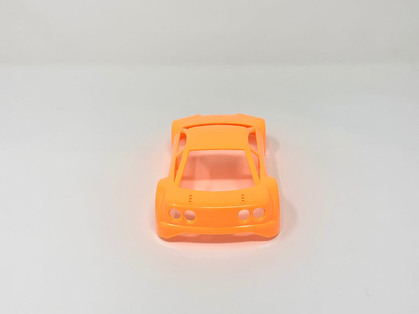 Jomurema GT01 car body in vibrant neon orange, showcasing sleek design and detailed exterior features.