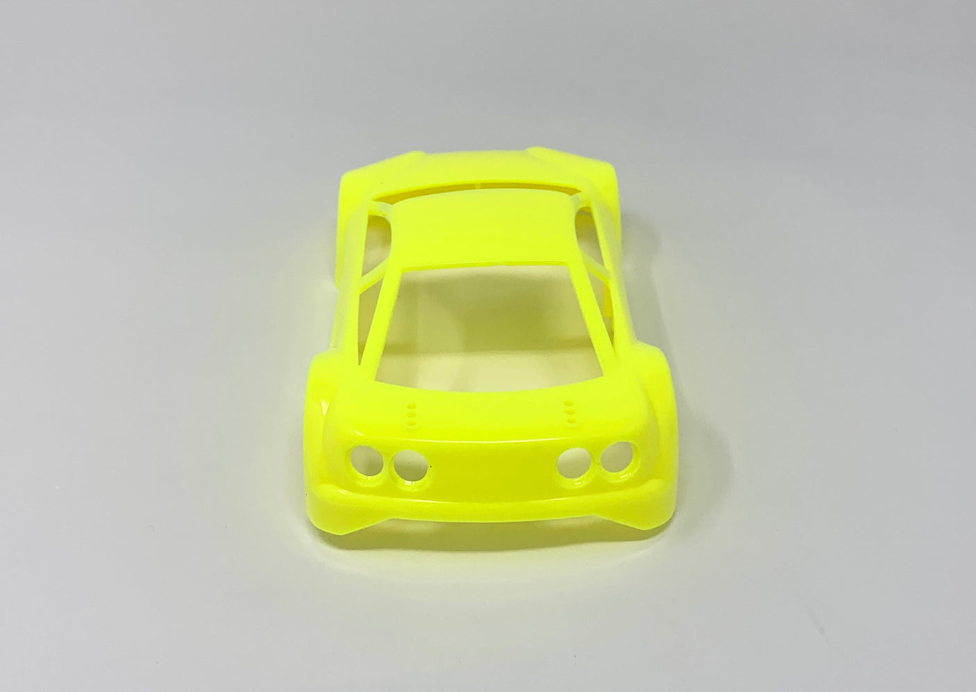 Jomurema GT01 car body in vibrant neon yellow, shown on a sleek vehicle with detailed close-up of the paint and design.