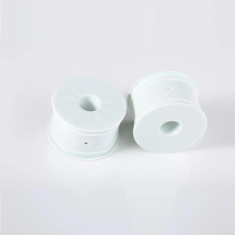 Pair of ivory LC Racing L6150 EMB Truggy wheels with detailed tread pattern for RC off-road vehicles.