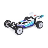 Losi 1/16 Mini-B 2WD RTR brushless buggy with detailed body and off-road tires on a racing track.