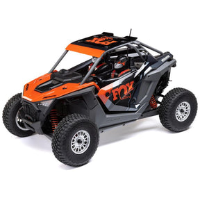 Losi Razor Rey 1/10 scale 4WD brushless desert buggy, shown with detailed body and off-road tires on a dirt track.