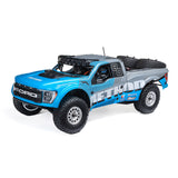 Losi 1/10 Baja Rey 2.0 Ford Raptor RC truck with brushless motor, detailed body, off-road tires, and 4x4 drivetrain.