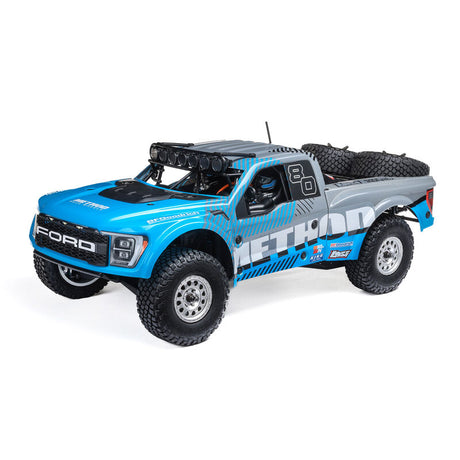 Losi 1/10 Baja Rey 2.0 Ford Raptor RC truck with brushless motor, detailed body, off-road tires, and 4x4 drivetrain.