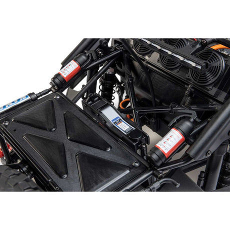 Losi 1/10 Baja Rey 2.0 Ford Raptor RC truck with brushless motor, detailed body, off-road tires, and 4x4 drive system.