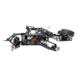 Losi 1/10 Baja Rey 2.0 Ford Raptor 4x4 RC truck with brushless motor on rugged terrain, detailed body and off-road tires.