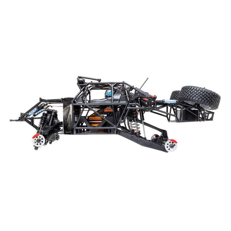 Losi 1/10 Baja Rey 2.0 Ford Raptor 4x4 RC truck with brushless motor on rugged terrain, detailed body and off-road tires.