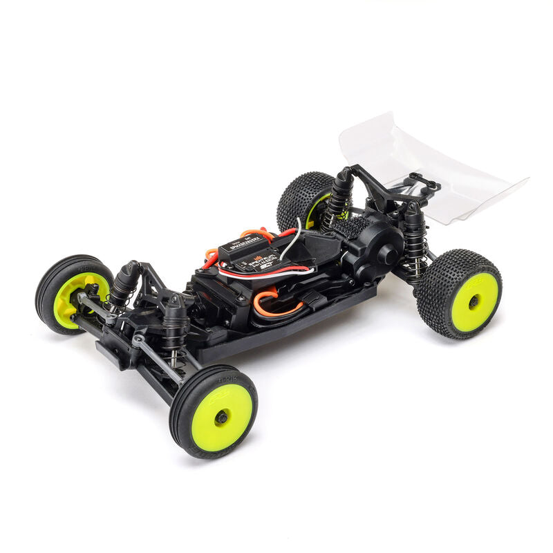 Losi Micro-B 2WD 1/24 scale buggy radio-controlled car on a track, with detailed body and off-road tires.