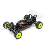 Losi Micro-B 2WD 1/24 scale buggy radio-controlled car on a track, with detailed body and off-road tires.