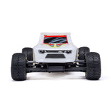 Losi Micro-T 2WD 1/28 scale truggy RC car with detailed body and off-road tires on a race track.