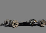 Atomic RC MRX Master Edition linkless 2WD RC car chassis with black and silver components, showcasing the precision engineering and design.