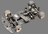 Atomic RC MRX Master Edition 2WD RC car chassis with sleek black design and detailed components for high-performance racing.
