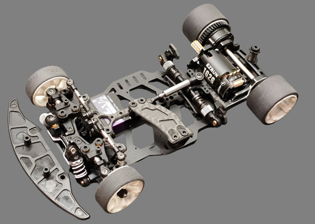 Atomic RC MRX Master Edition 2WD RC car chassis with sleek black design and detailed components for high-performance racing.