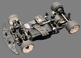Atomic RC MRX Master Edition Linkless 2WD chassis with sleek black design and intricate component layout for high-performance RC racing.