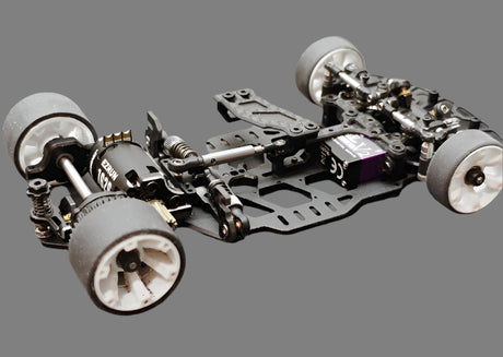 Atomic RC MRX Master Edition 2WD RC car chassis with sleek design and durable construction, shown from a side angle.