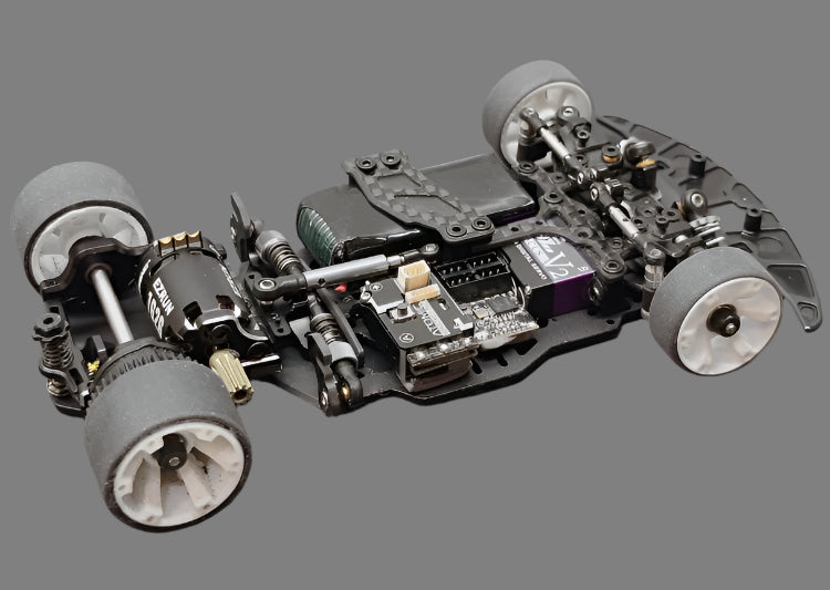 Atomic RC MRX Master Edition Linkless 2WD chassis with detailed components and black finish, designed for high-performance remote control cars.